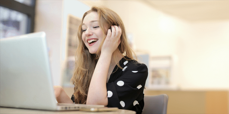 Young woman using her laptop on a sales video call in her home office.