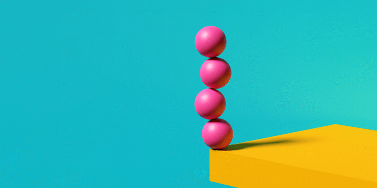 4 pink balls balancing on a yellow table with a turquoise background