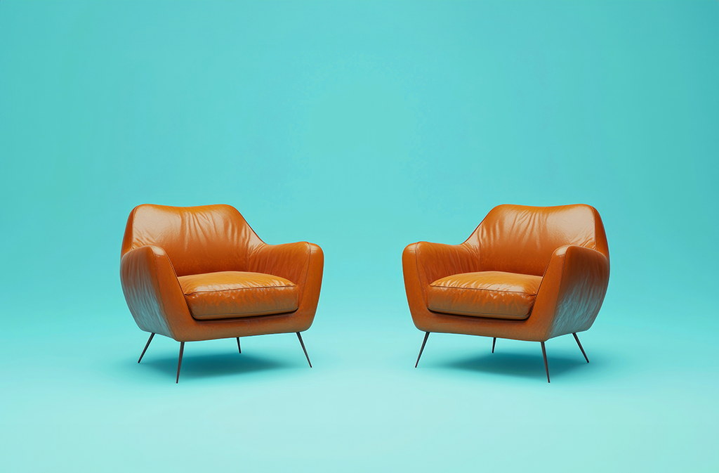 Two arm chairs turned toward each other on a turquoise background