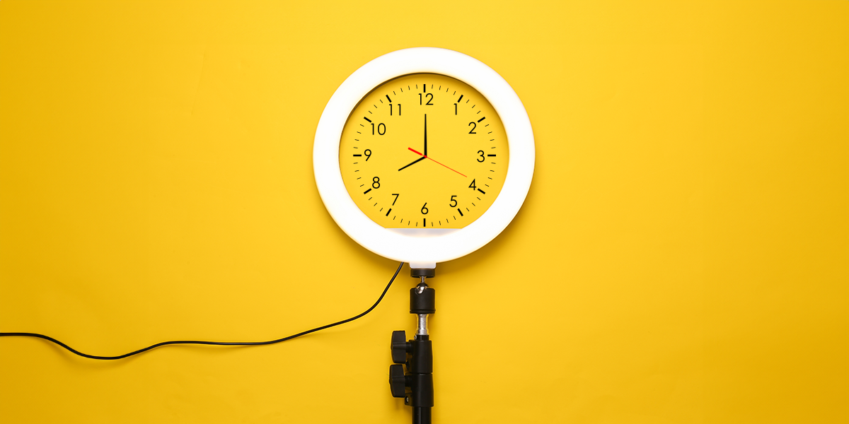 Ring light with a clock face on a bright yellow background