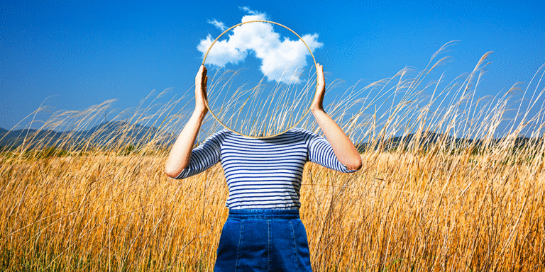 photorealistic image of a headless woman holding up a glassless mirron with clouds floating in the background. Standing in a golden field with bright blue sky.