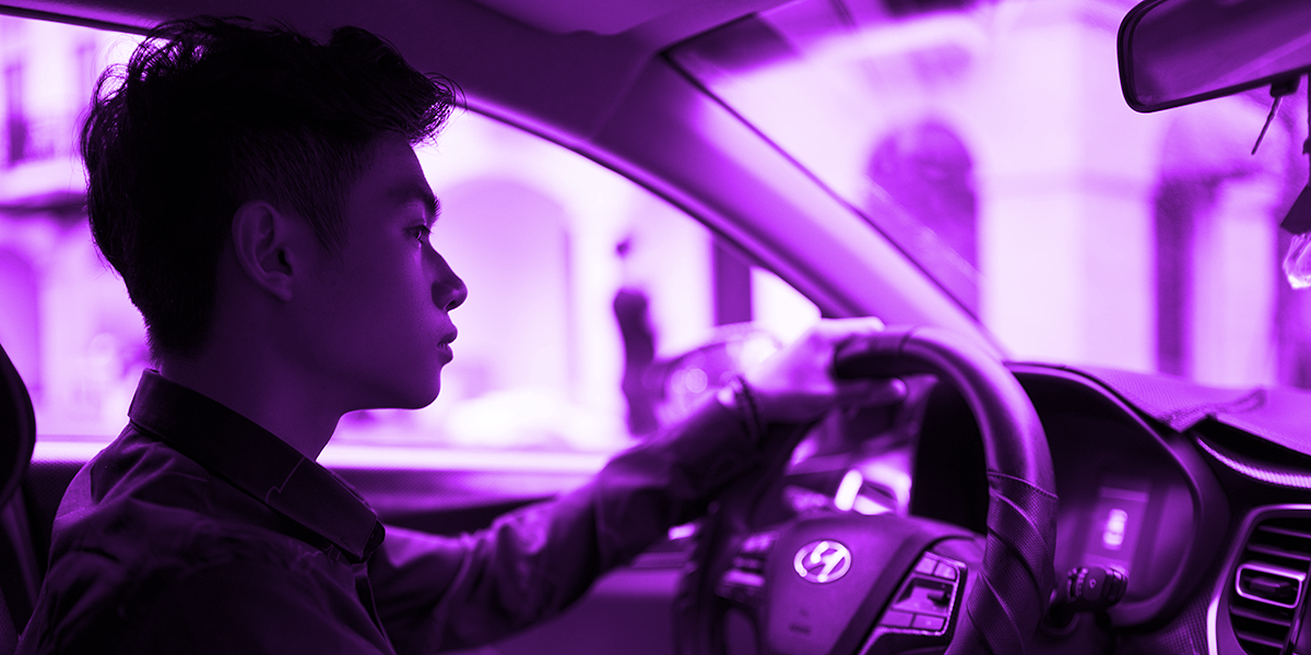 Young man taking initiative, in the driver's seat of a car